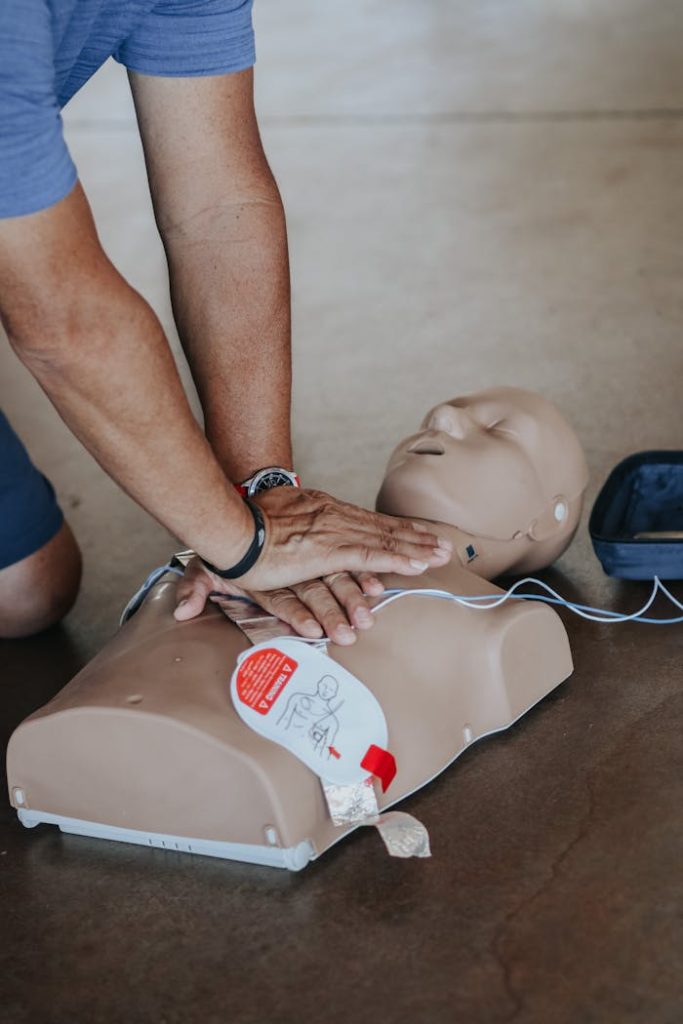 hands-of-person-doing-cpr-on-training-dummy-11655091 BLS-AED